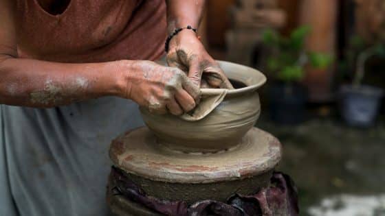 woman making clay pot